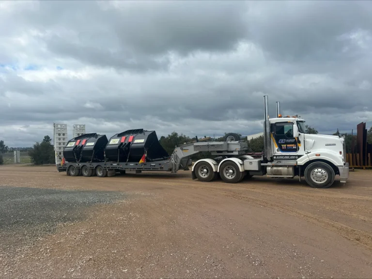 Truck carrying large equipment on trailer.